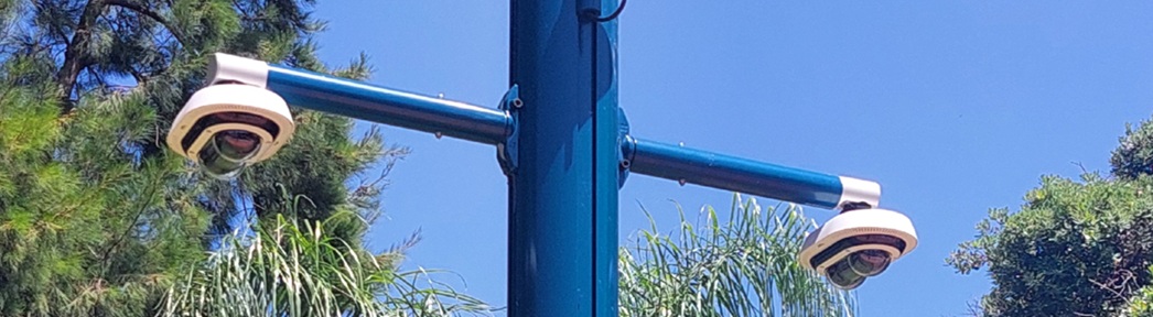 A CCTV camera and sign.