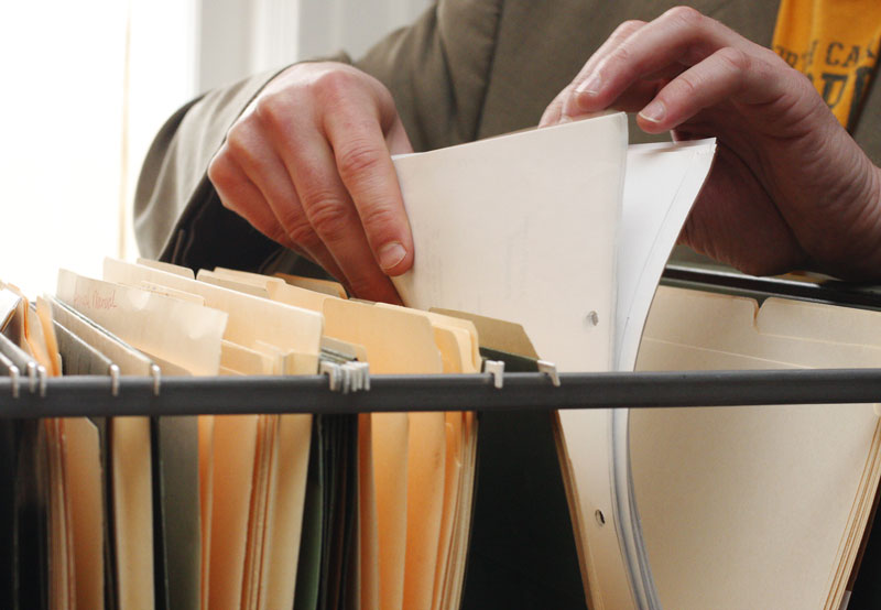 Man looking through files in drawer