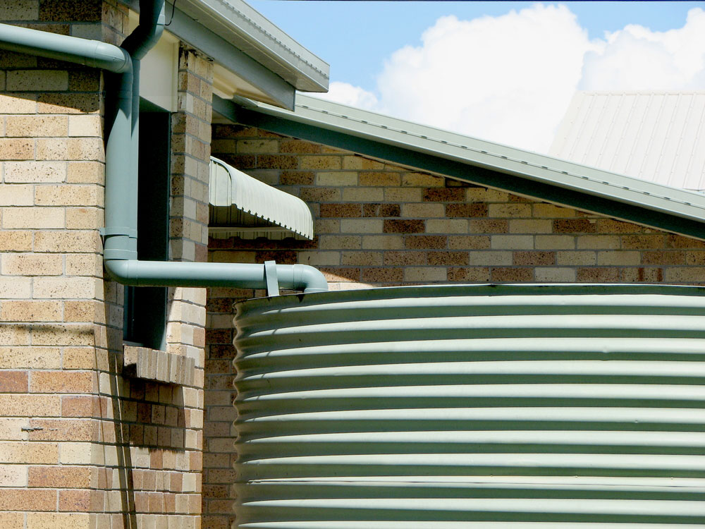 Rainwater tank outside a house.