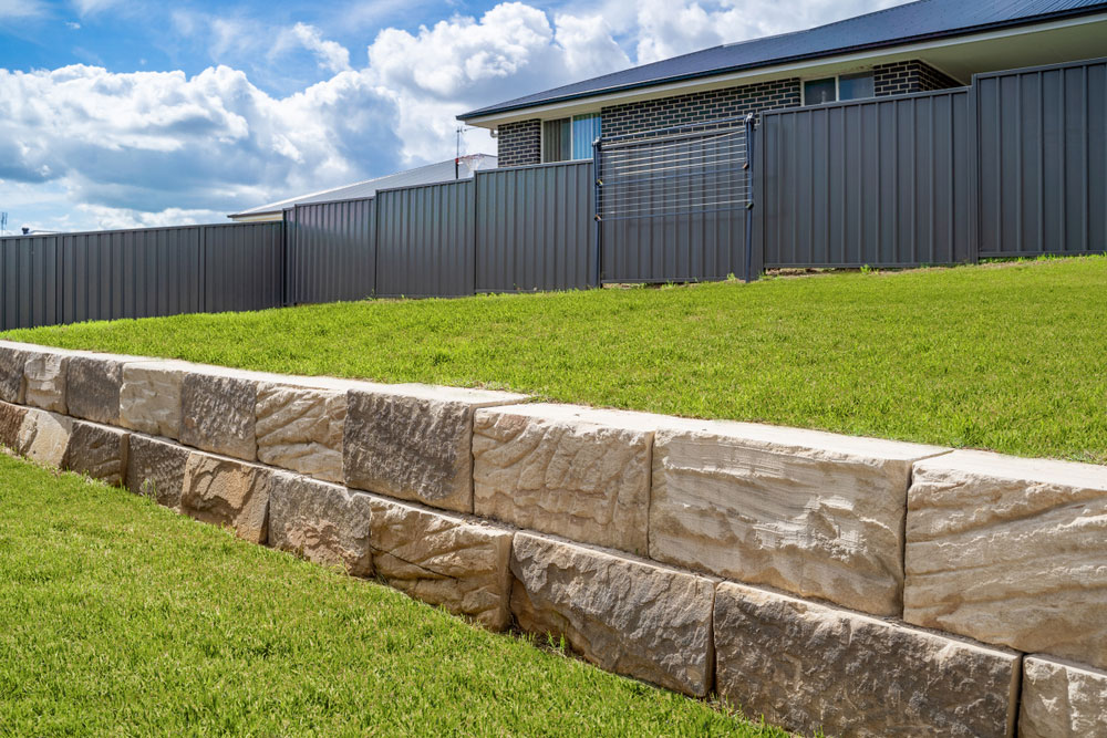 Limestone retaining wall in a residential backyard.