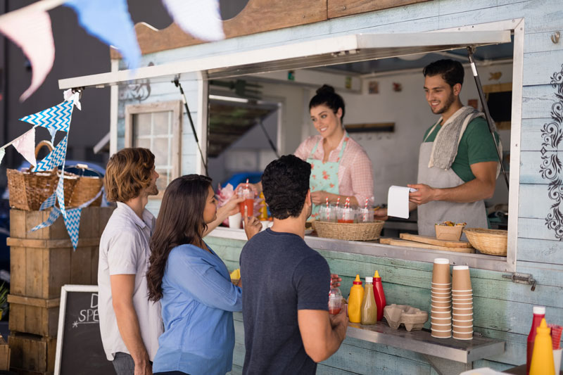 Food Truck staff serving food to customers 