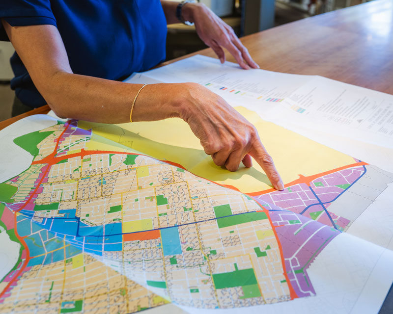 Woman Pointing on a Map