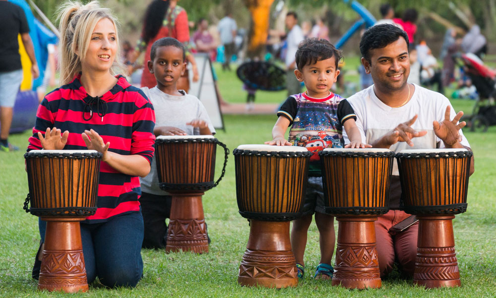 People playing African drums at community event