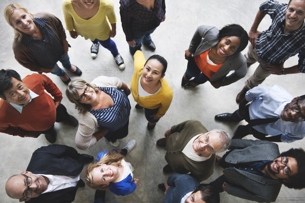 Diverse group of people looking up.