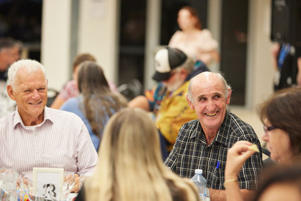 Adults clapping and laughing at event