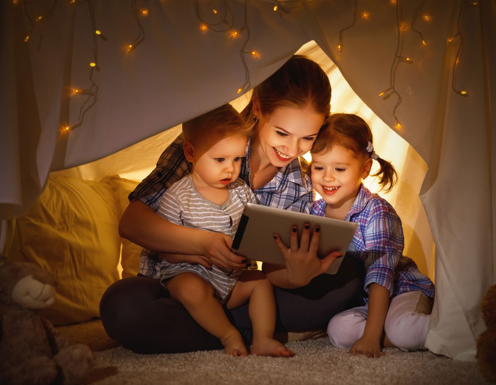 Mother an children reading on tablet