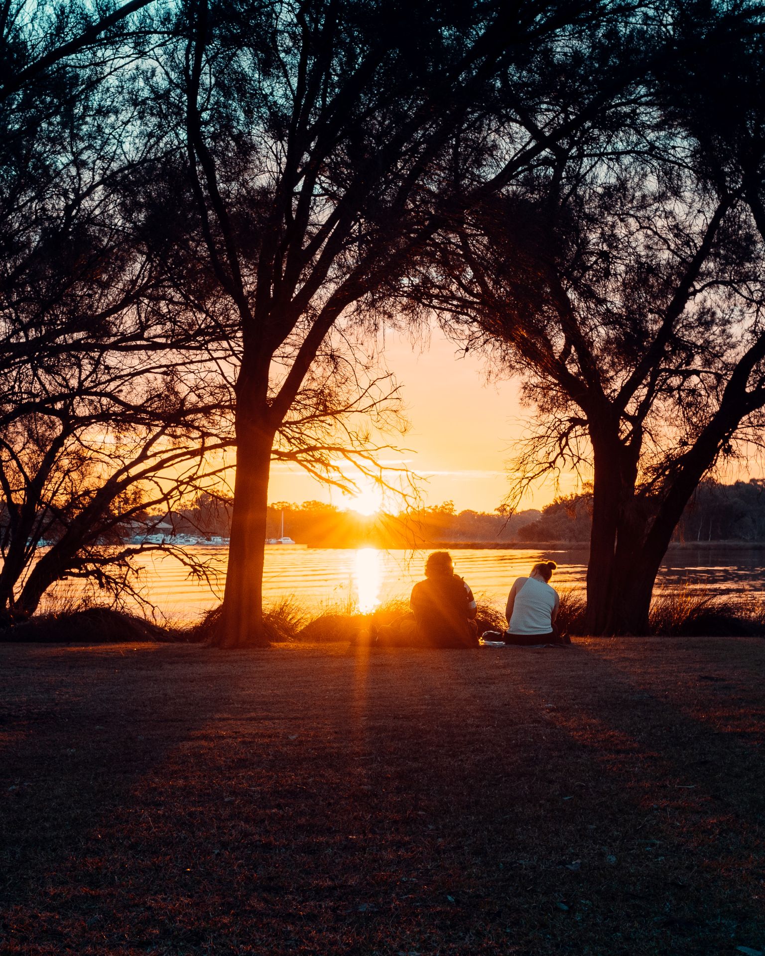 Two people watching the sunset at Adachi Park