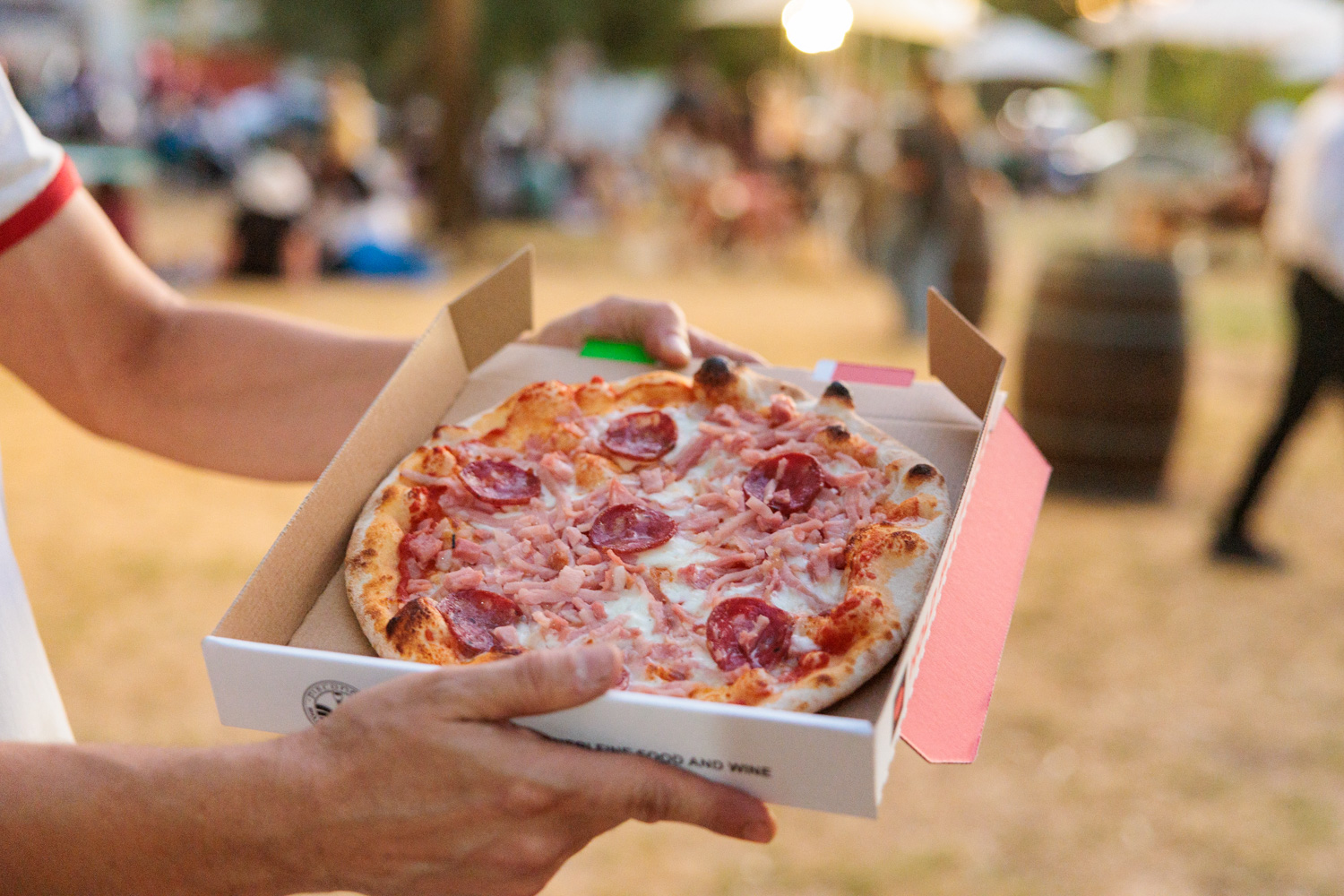 Holding a box of pizza