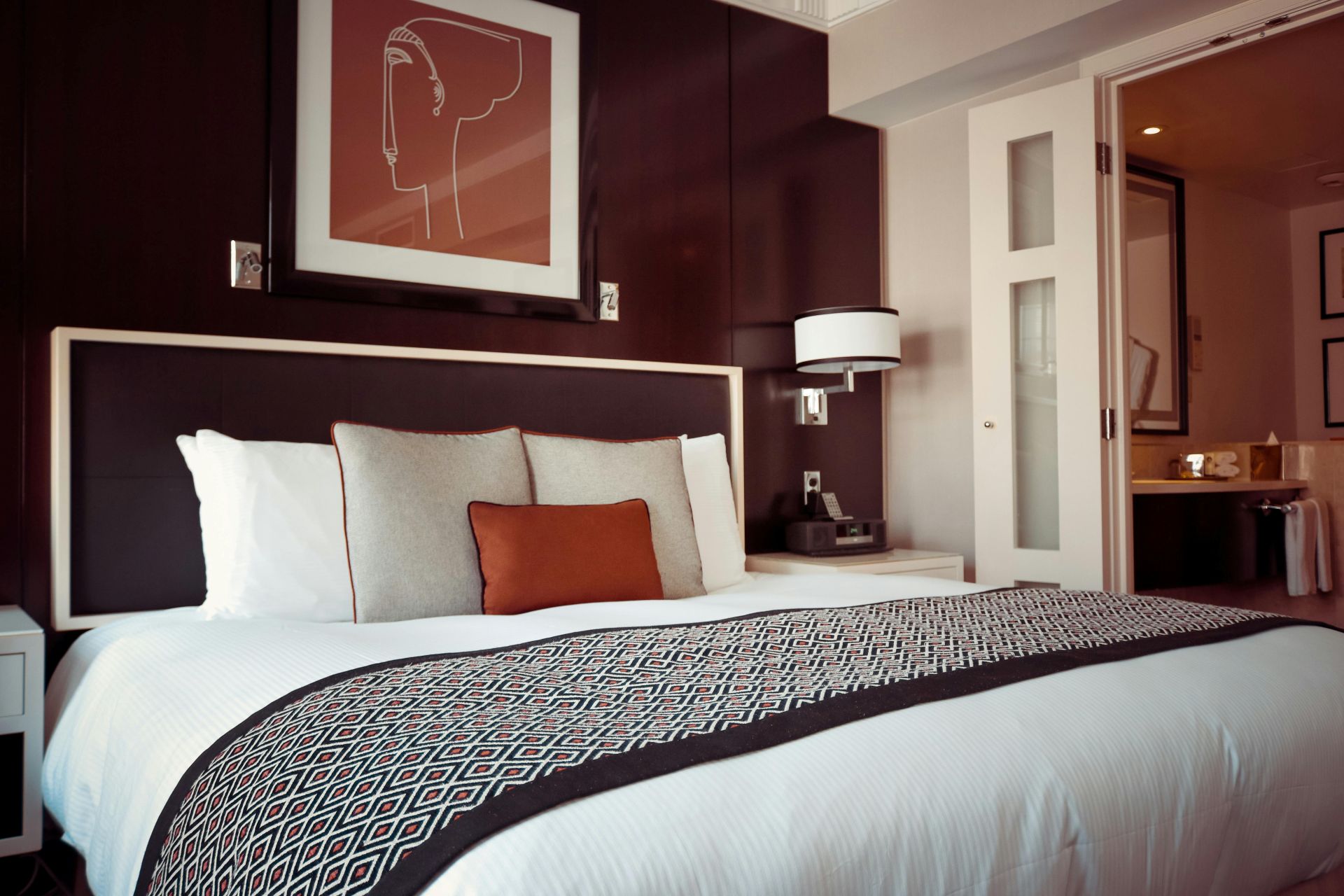 A burgundy and orange hotel suite