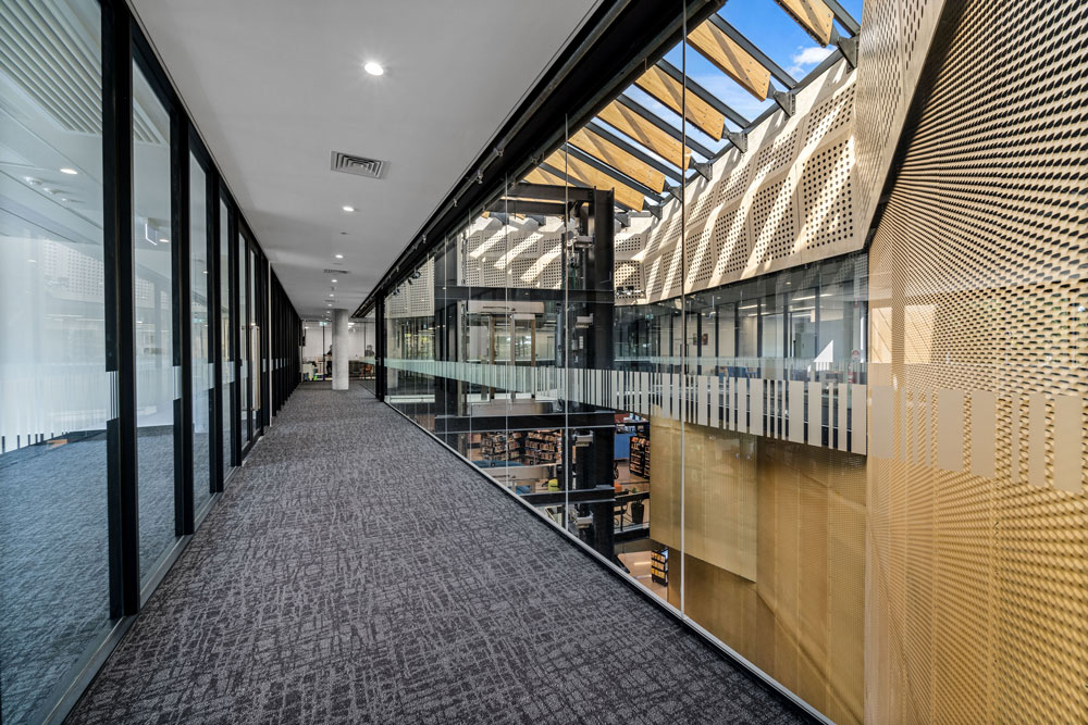 Glass corridor showing central voice and office space part of the Second Floor.
