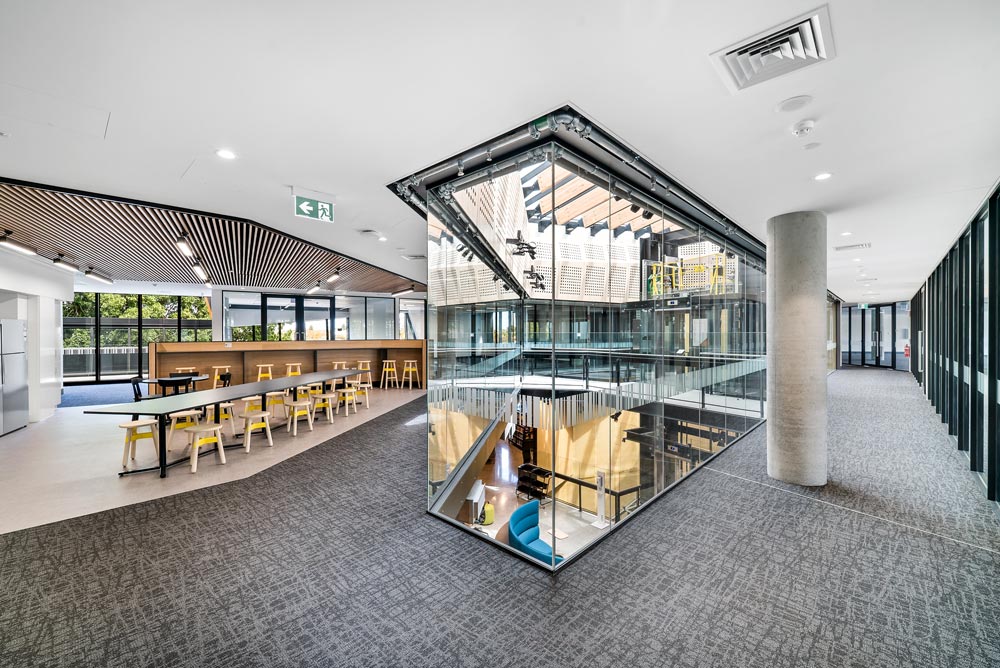 View of second floor office space containing kitchen and central void.