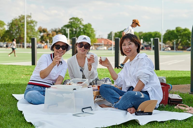Three people drink tea and enjoying conversation at Wilson Park