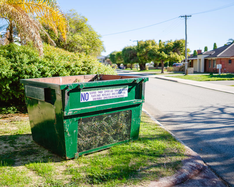 Green bulk bin on verge