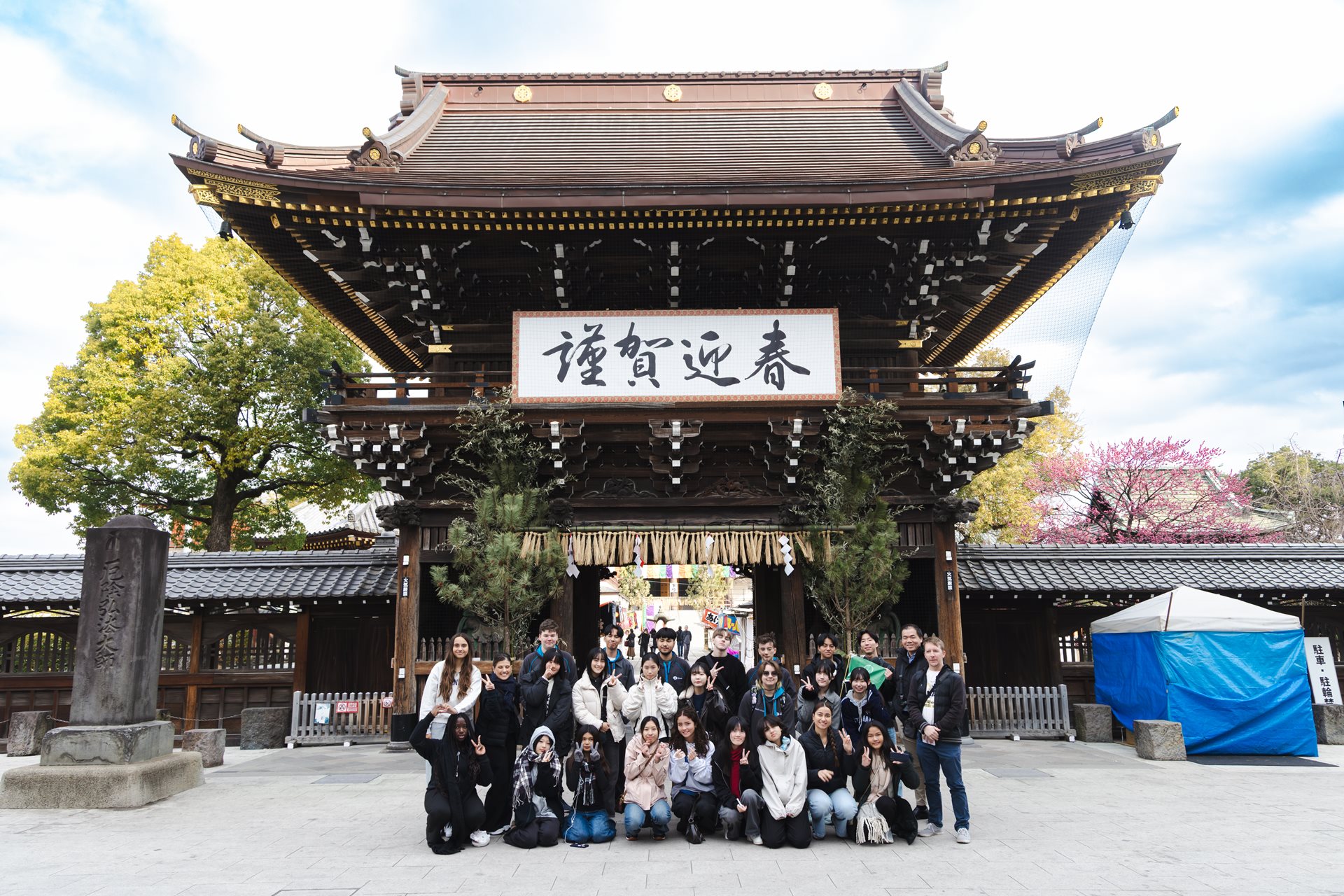A group of students in front of a Japanese temple