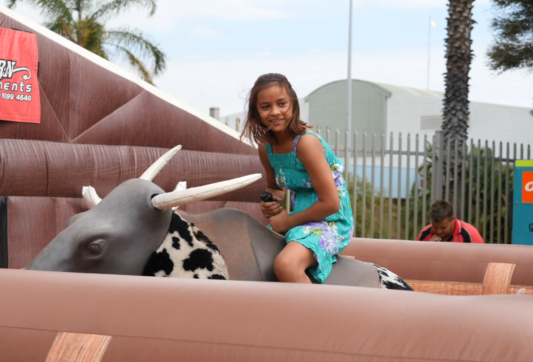 Girl on a bucking bull.