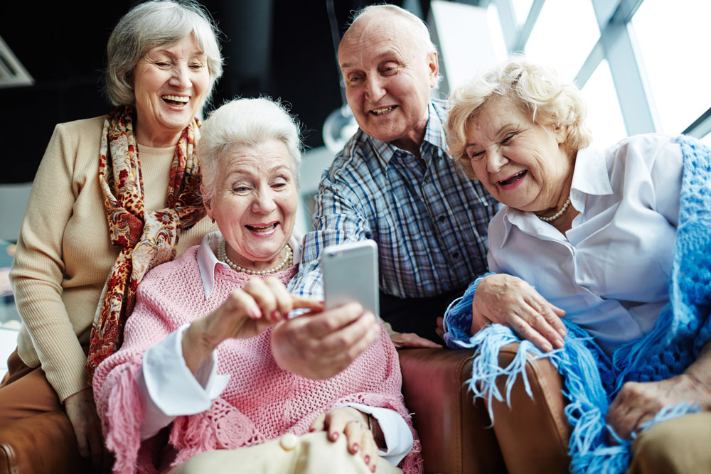 Group of seniors looking at smartphone.