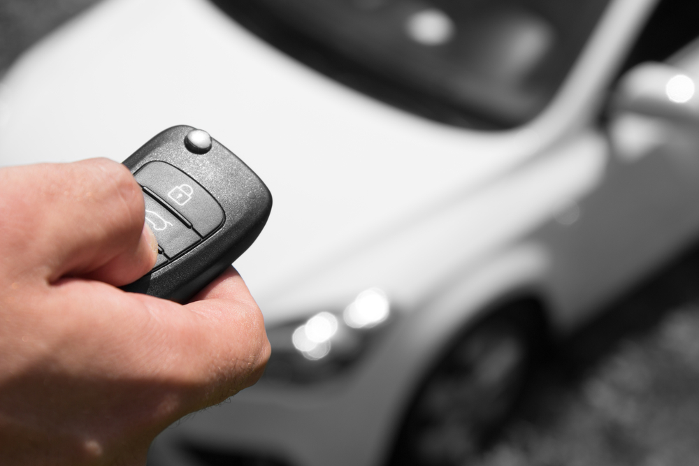 Man locking his car in the carpark.