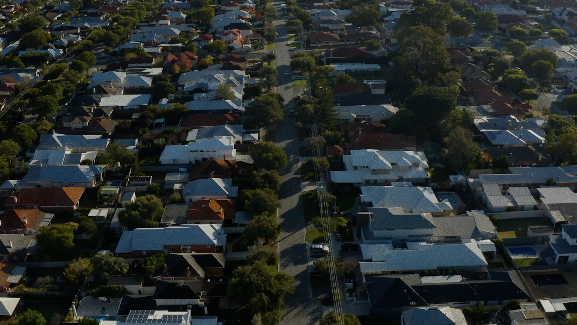 Aerial photo of houses on a street.