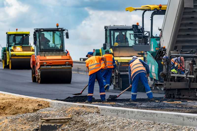 Men working on noisy work site with machinery