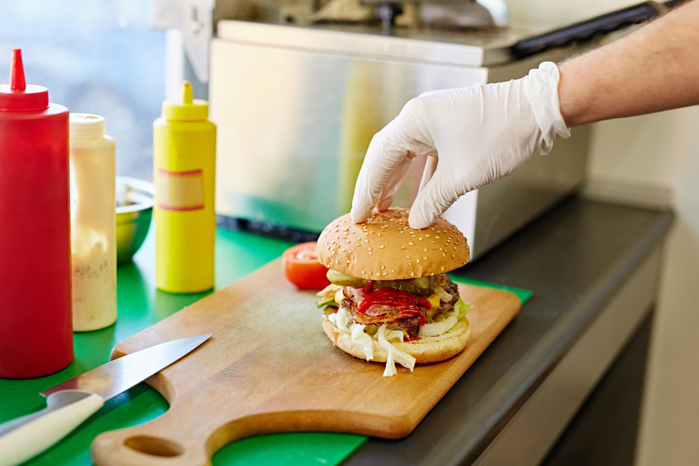 Safe preparation of a hamburger using gloves