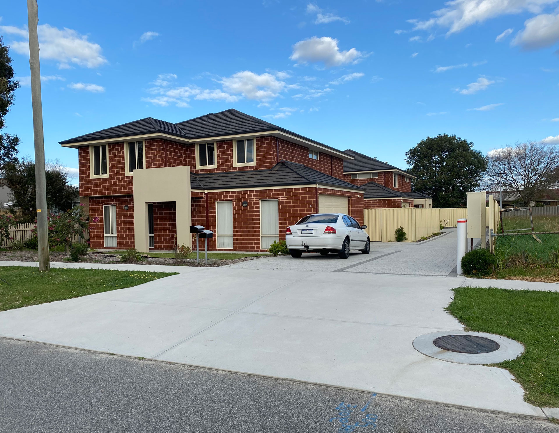 Cars in the driveway of a house.