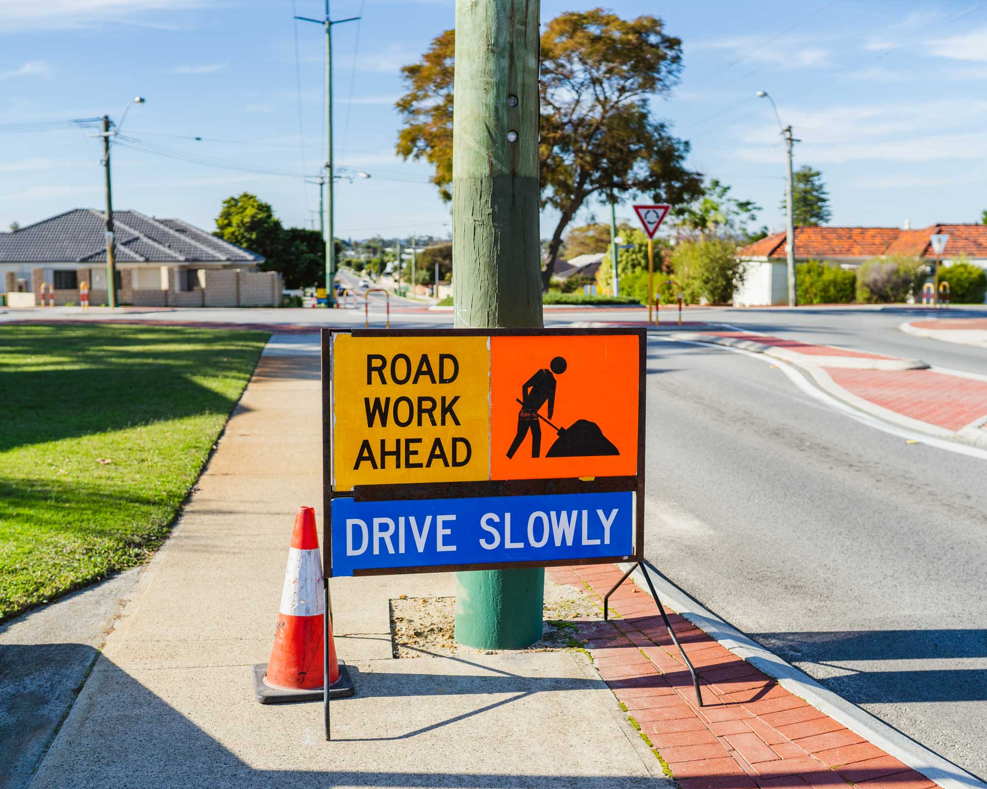 Roadwork sign instructing cars to drive slowly.